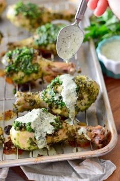 broccoli and chicken are being cooked on a grill with a spatula in it