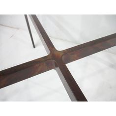 a close up view of a metal table with cross design on the top and bottom