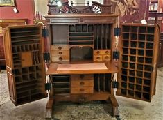 an old fashioned desk with lots of drawers and shelves on it's sides in a store