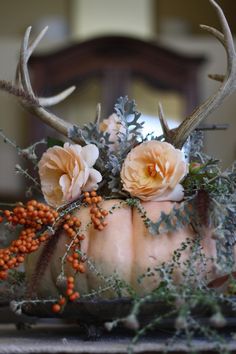 an antlers head with flowers and berries on it is shown in the instagram