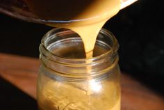 a jar filled with liquid being poured into it