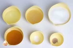 four different types of eggs are shown on a white surface