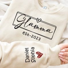 Link to add on a message card, gift card: https://www.etsy.com/listing/1462461713/godmerch-custom-gift-message-card Mimi Christmas Sweatshirt, Custom Mimi Est And Kids, Grandma Gift TH Sweatshirt If you looking for a personalized t-shirt to show your love to your family, it's will be best choice. Our Classic T-Shirt serves as the perfect short-sleeved shirt for your unique, funny, or personalized designs. Features such as a lay flat collar and a classic unisex cut will make this your new favorite t-shirt. Brand: Gildan Heavy weight fabric Classic unisex makes this an easy fit Size up if you want something roomier Our shirts include: - Sport Grey And Antique Heathers: 90% Cotton | 10% Polyester - Safety Colors And Heathers: 50% Cotton | 50% Polyester - Another colors: 100% cotton Machine wa Flat Collar, Grandma Gift, Comfy Sweatshirt, Sweatshirt Christmas, Card Gift, Gift Message, Grandma Gifts, Shirt Brand, Message Card