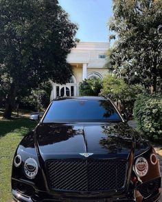 a black car parked in front of a house