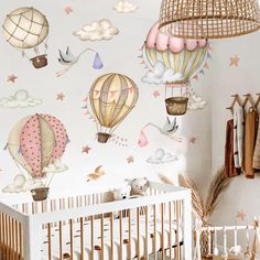 a baby's room with hot air balloons and stars on the wall