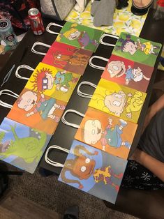 a table topped with paper cut outs covered in cartoon characters