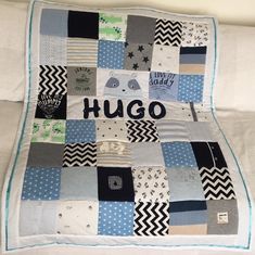 a quilt made to look like a blanket with the word hug written on it in black and white