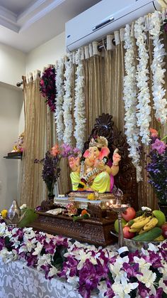 there is a gandap with flowers and fruit on the table