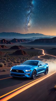 a blue ford mustang driving down a road at night with the milky in the background