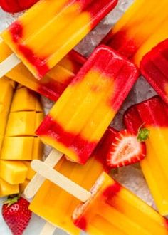 several popsicles with strawberries and oranges on them