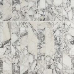 white and black marble tiles are arranged in an irregular grid pattern, which is very similar to the same type of tile