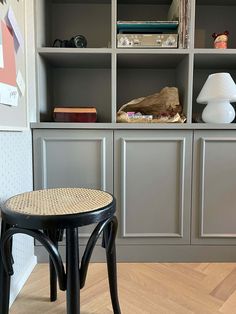 a chair and table in front of some bookshelves