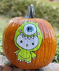 a pumpkin decorated with an image of a dinosaur on it's face and eyes