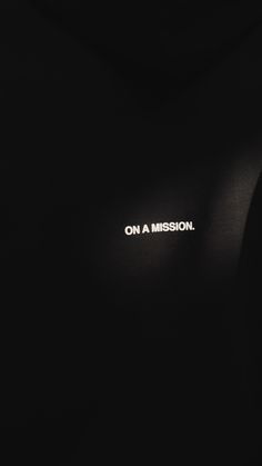 the word on a mission is projected in white light against a black background that appears to be dark