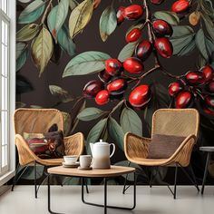 two chairs and a table in front of a wall mural with fruit on the branches