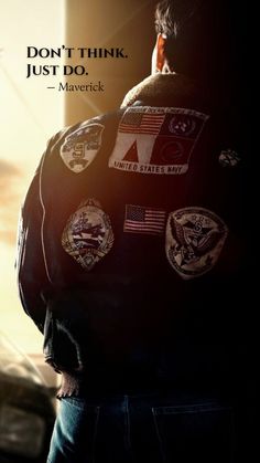 the back of a man's jacket with patches on it and an american flag