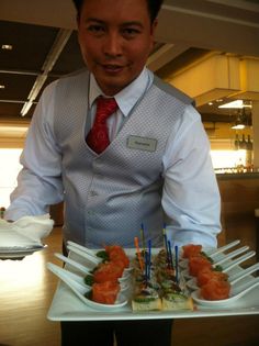 a man holding a tray with food on it