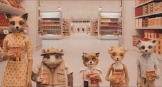 three stuffed animals are standing in a store with shelves full of food and condiments