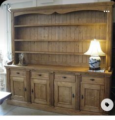 a large wooden bookcase sitting next to a lamp