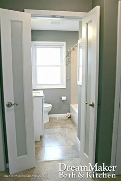 an open door leading to a bathroom with a sink and toilet