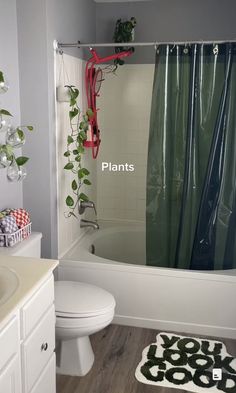 a bathroom with plants growing on the shower curtain