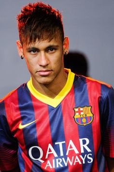 a young man with red hair wearing a soccer uniform