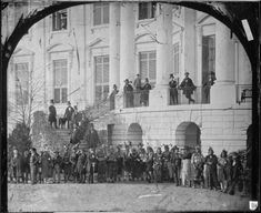 an old black and white photo of people standing in front of a building with stairs