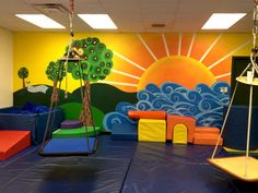 children's play area with swings, slides and climbing walls painted on the wall