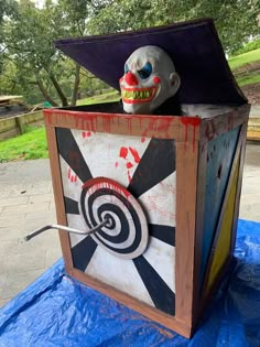 an odd looking box with a creepy clown face on it's head and eyes