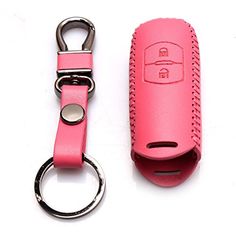 a pink leather keychain with a metal ring on the front and back side