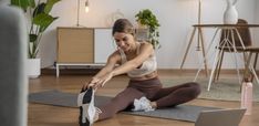 a woman stretching out on her yoga mat