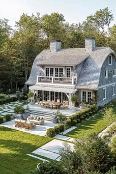 an aerial view of a large house in the middle of a lush green yard and trees