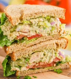 a cut in half sandwich sitting on top of a cutting board