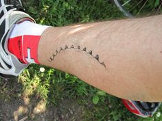 a close up of a person's arm with a tattoo on it and the words,