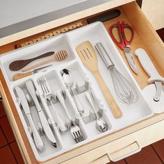 a drawer with utensils and spoons in it