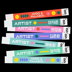 four different colored wristbands with the words art and artist written on them in various languages