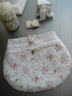 a white purse sitting on top of a wooden table next to some other items and decorations