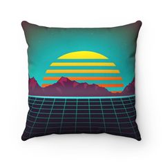 a pillow with an image of the sun in front of mountains and grids on it