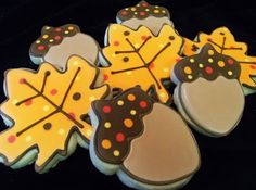 decorated cookies in the shape of leaves and acorns