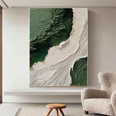 an abstract painting hangs on the wall next to a chair and ottoman in a modern living room