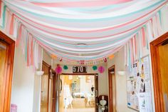 the hallway is decorated with pink, blue and white streamers