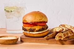 a hamburger and some fries on a cutting board