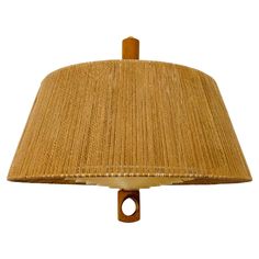 a lamp that is made out of wood and has a brown shade on the top