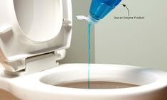 a blue liquid is being poured into a white toilet