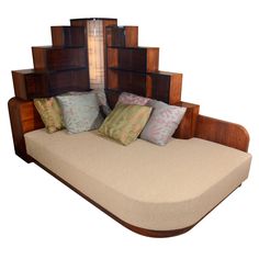 a couch made out of wood with pillows on it