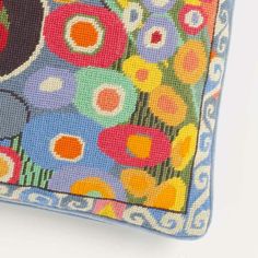 a colorful flowered purse is shown on a white surface