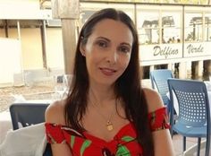 a woman is sitting at an outdoor table