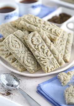 some cookies are on a plate with spoons