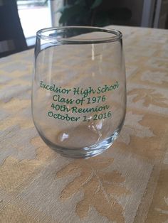 a wine glass that has been placed on a table with a name etched into it