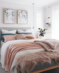 a bedroom with white walls and neutrals in the color scheme, including pink, gray,